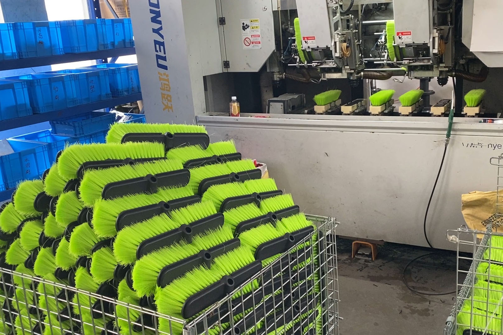 ONYEU automated tufting line producing lime-green cleaning brushes