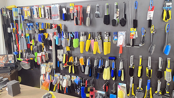 Winking Home product showroom — cleaning brush display wall with 2500+ SKUs
